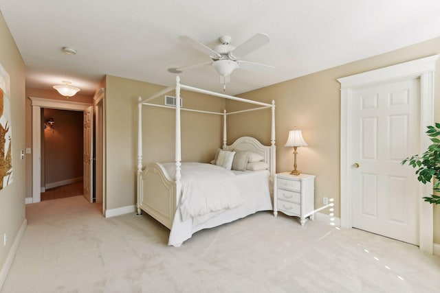 bedroom featuring ceiling fan and light carpet