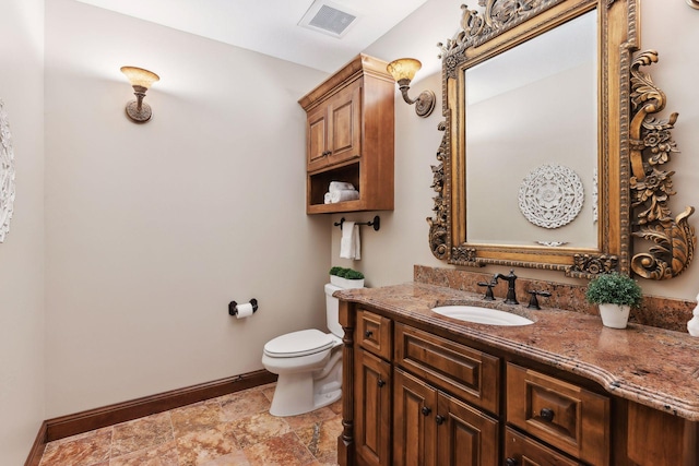 bathroom featuring toilet and vanity