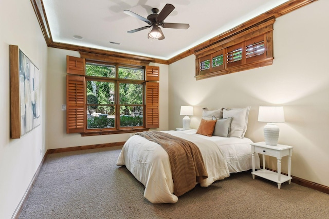 carpeted bedroom with ceiling fan and ornamental molding