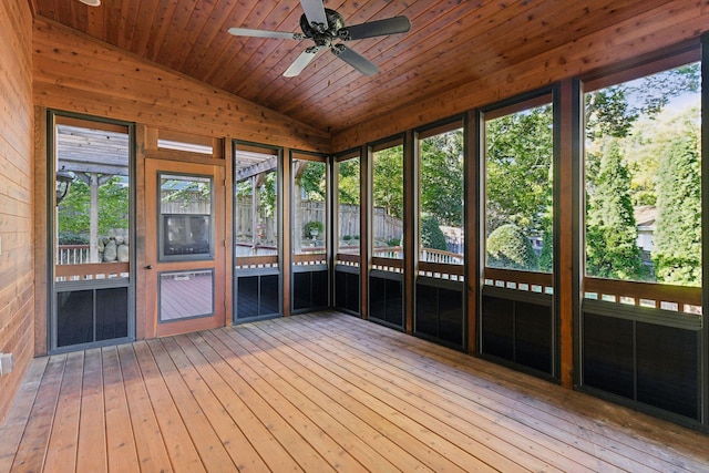 unfurnished sunroom with wood ceiling, lofted ceiling, and ceiling fan