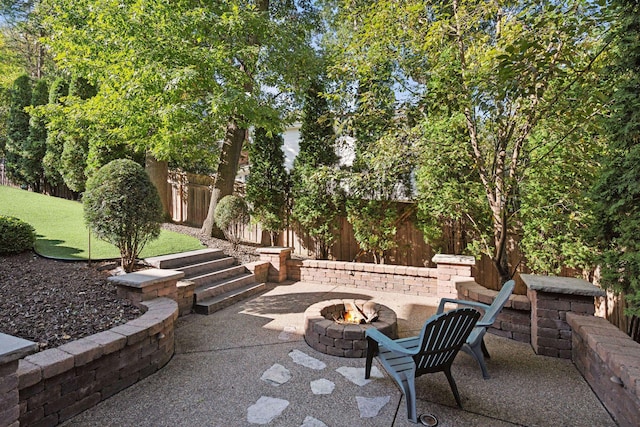 view of patio / terrace featuring an outdoor fire pit