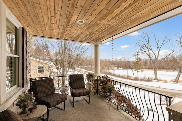 view of snow covered back of property