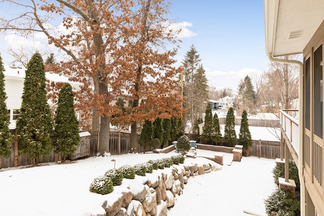 view of yard layered in snow