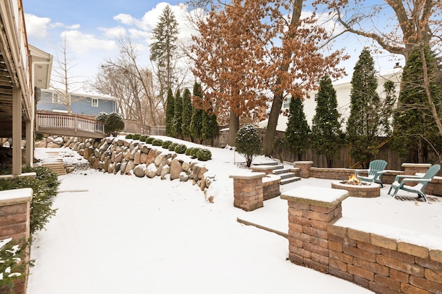 yard covered in snow featuring a fire pit