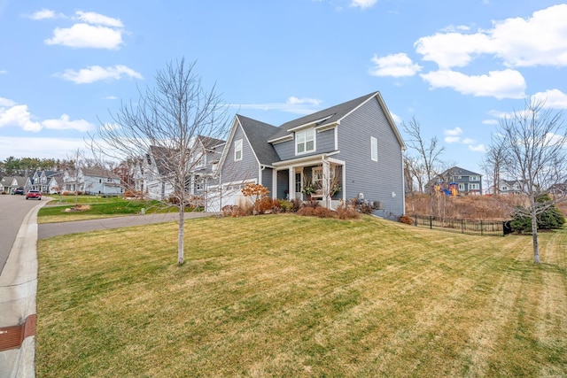 view of front of home featuring a front yard, a porch, and a garage