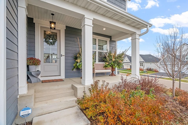 view of exterior entry featuring covered porch