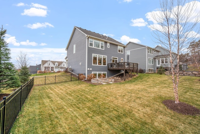 back of house with a yard and a wooden deck