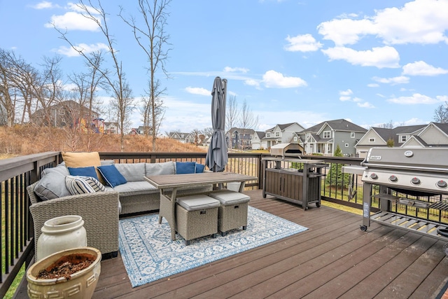 wooden terrace featuring area for grilling and an outdoor hangout area