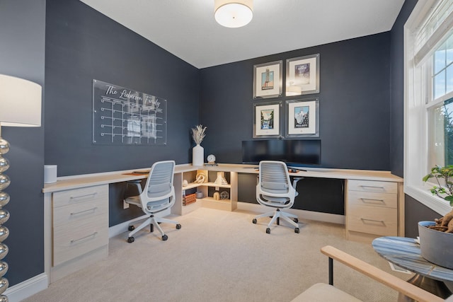 carpeted office space featuring built in desk