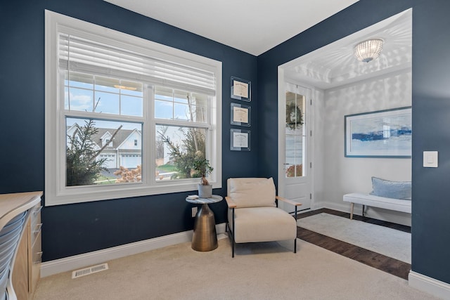 living area featuring carpet flooring and a notable chandelier