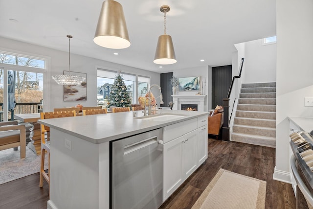 kitchen with white cabinets, pendant lighting, sink, and appliances with stainless steel finishes