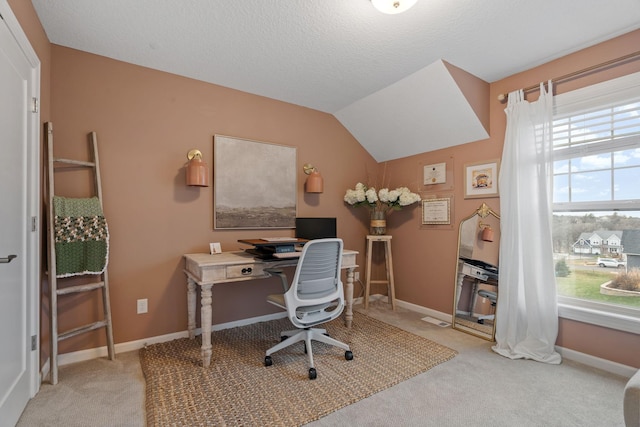 office area featuring light carpet, a wealth of natural light, and lofted ceiling