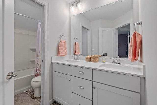 full bathroom with vanity, shower / bath combo, and toilet