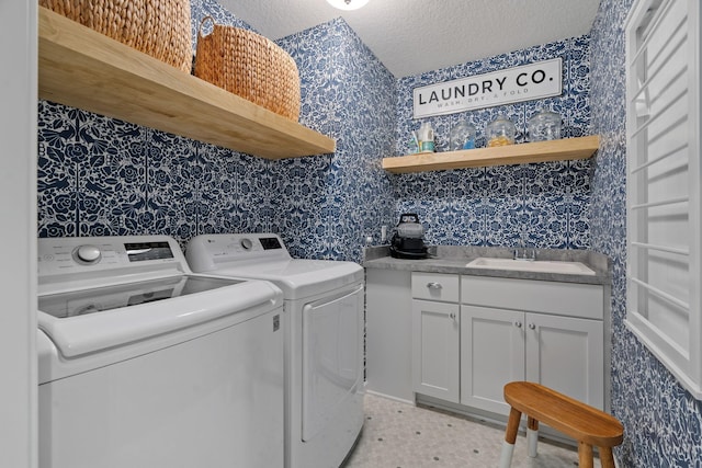 laundry area featuring cabinets, a textured ceiling, sink, light tile patterned floors, and independent washer and dryer