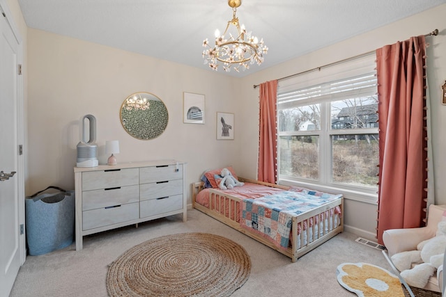 bedroom featuring a chandelier and light colored carpet