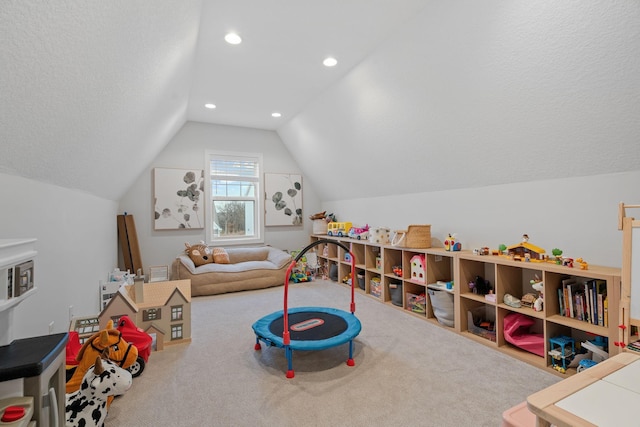 recreation room featuring carpet flooring, a textured ceiling, and lofted ceiling