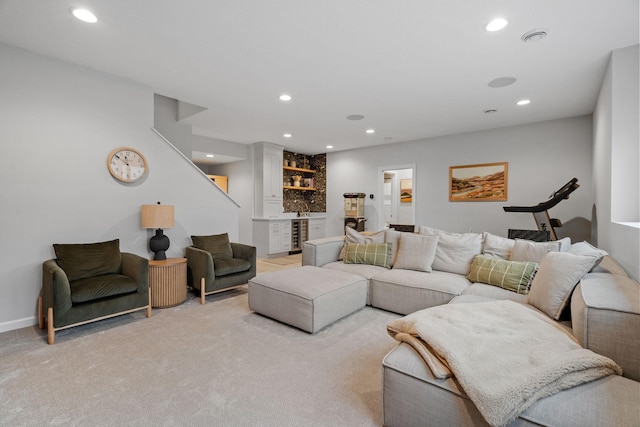 living room with indoor bar and light colored carpet