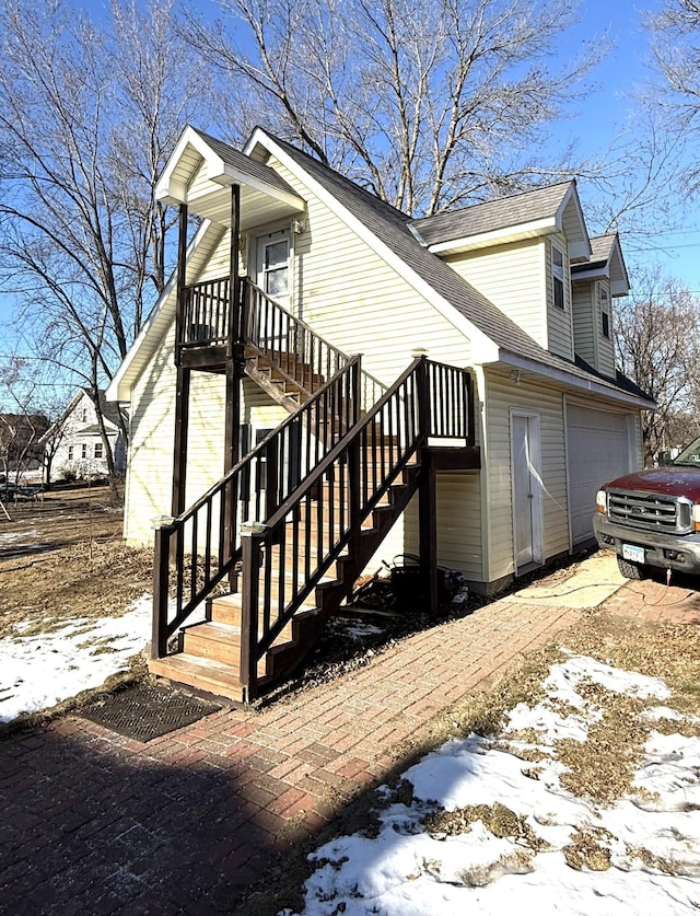 view of snow covered exterior featuring a garage