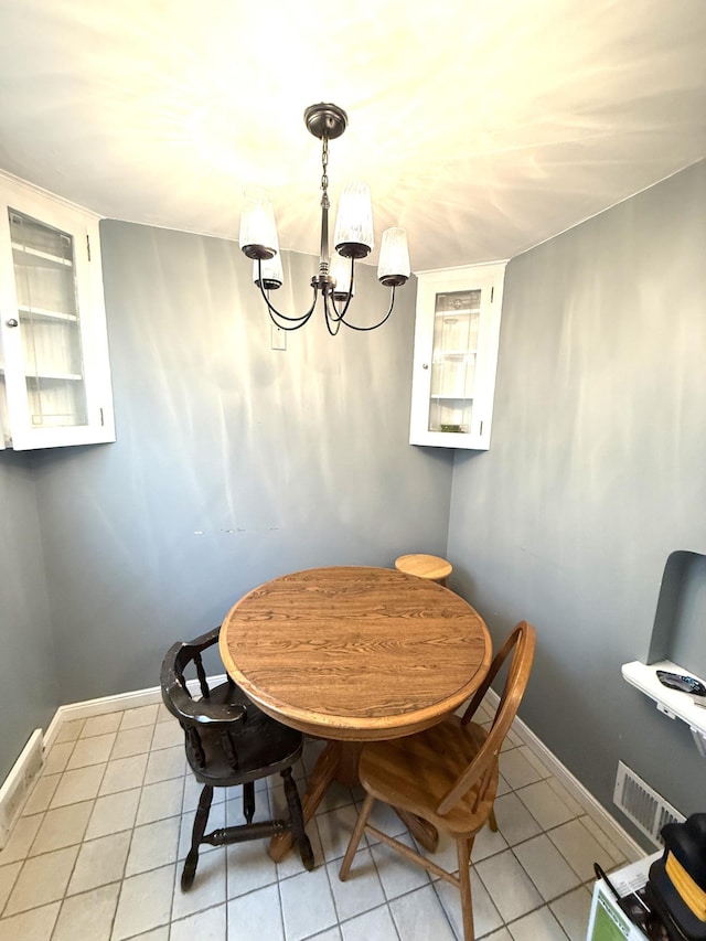 dining room featuring light tile patterned floors and an inviting chandelier