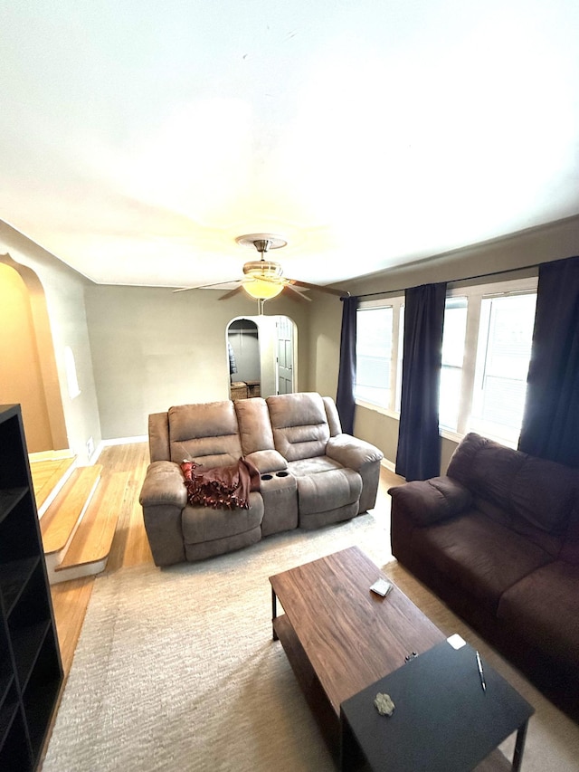 living room with wood-type flooring and ceiling fan