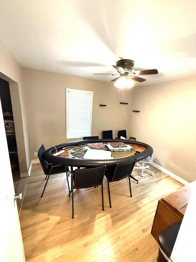 dining space featuring light wood-type flooring and ceiling fan