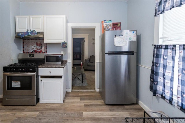 kitchen featuring white cabinets, stainless steel appliances, and light hardwood / wood-style floors