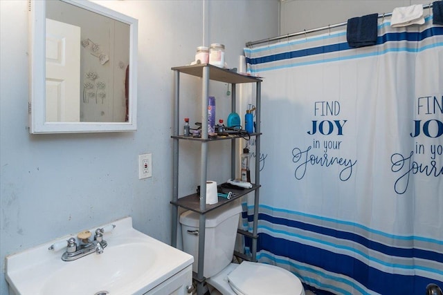 bathroom with walk in shower, vanity, and toilet