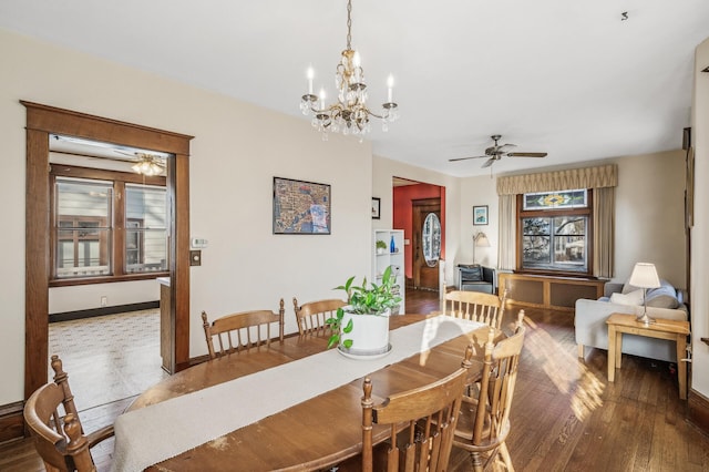 dining space featuring ceiling fan with notable chandelier and hardwood / wood-style flooring