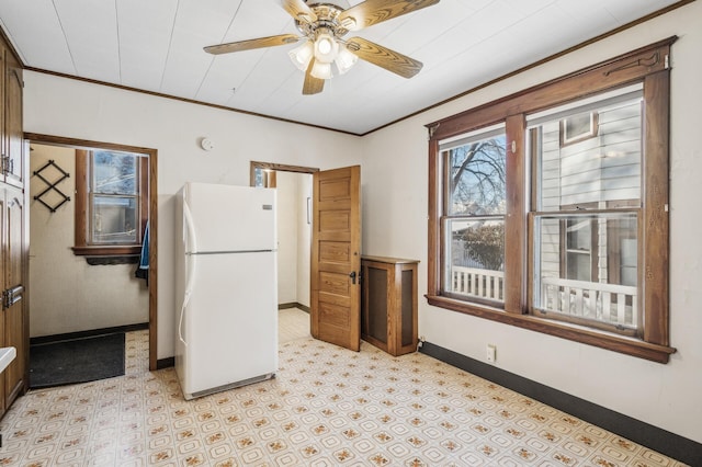 kitchen with white fridge, ceiling fan, and crown molding