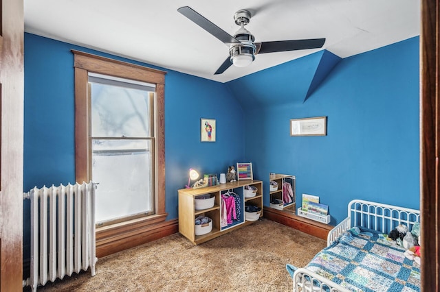 bedroom with ceiling fan, radiator, carpet, and lofted ceiling