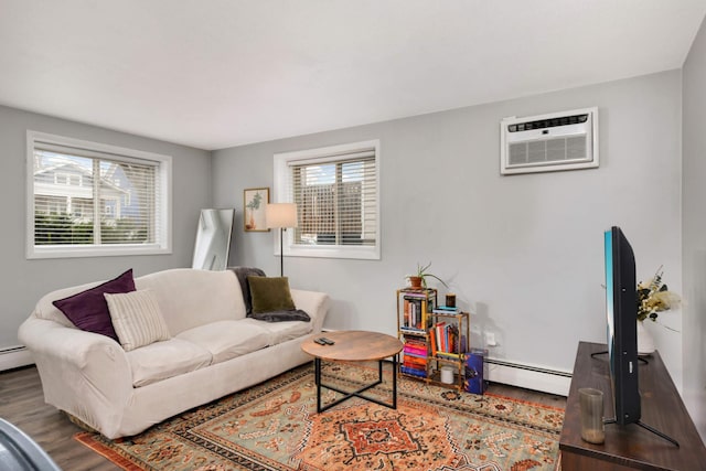 living room with an AC wall unit, a baseboard radiator, and hardwood / wood-style flooring