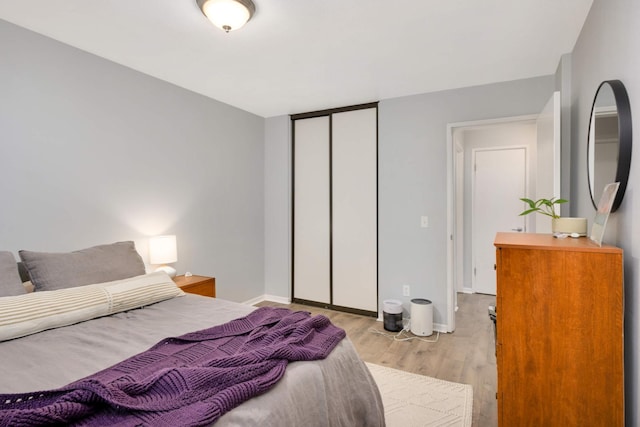 bedroom with a closet and light wood-type flooring