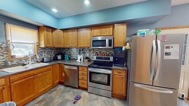 kitchen featuring appliances with stainless steel finishes, backsplash, and sink