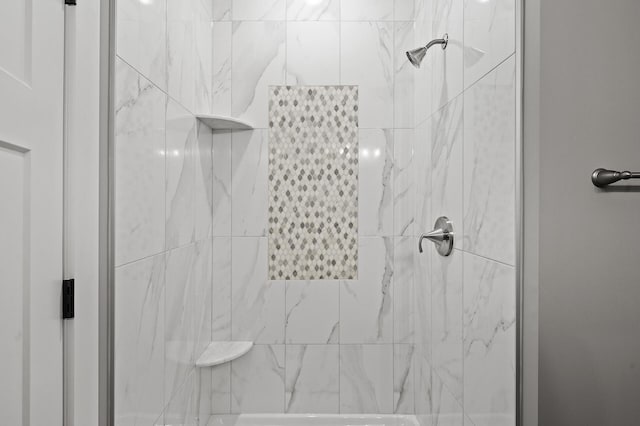 bathroom with tiled shower