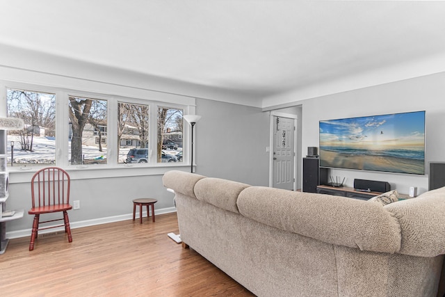 living area with wood finished floors and baseboards