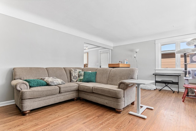 living room featuring light wood-style floors and baseboards