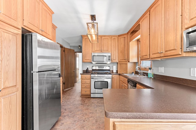 kitchen with dark countertops, light brown cabinets, a peninsula, stainless steel appliances, and a sink