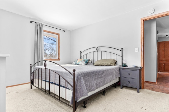 carpeted bedroom featuring baseboards