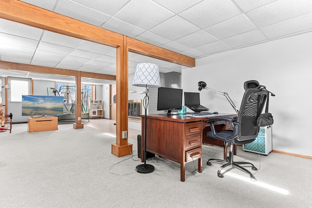 office space with carpet flooring, baseboards, and a drop ceiling