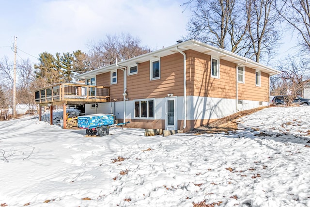 snow covered property featuring a deck