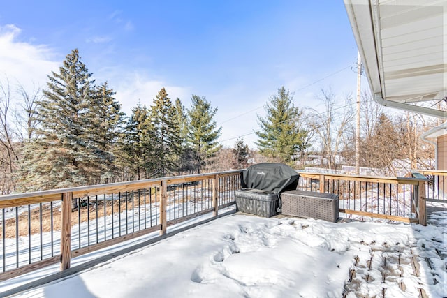 snow covered deck with a grill