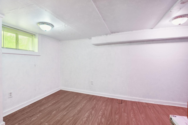 basement with hardwood / wood-style floors