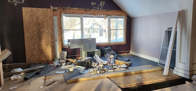 misc room featuring lofted ceiling and a notable chandelier