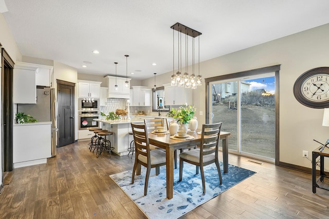 dining room featuring dark wood-type flooring and sink