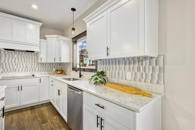 kitchen featuring decorative backsplash, white cabinets, stainless steel dishwasher, and sink