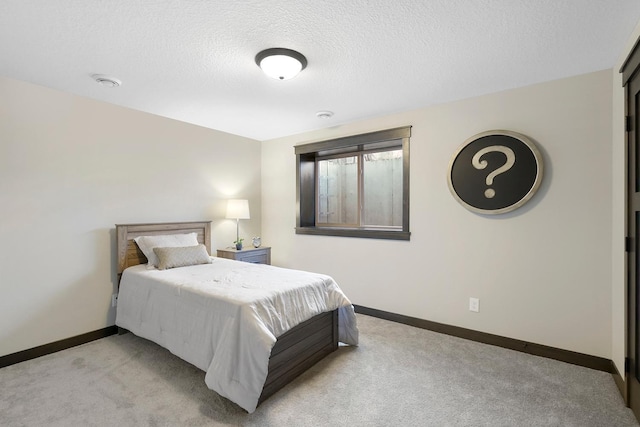 carpeted bedroom with a textured ceiling