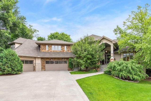 view of front of home with a garage and a front lawn