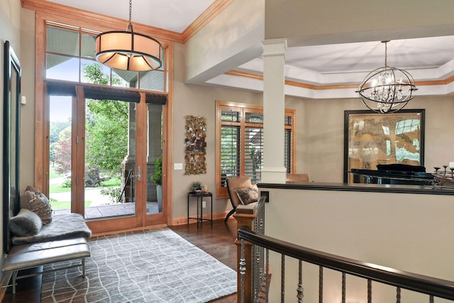 foyer with ornamental molding, plenty of natural light, and dark hardwood / wood-style flooring