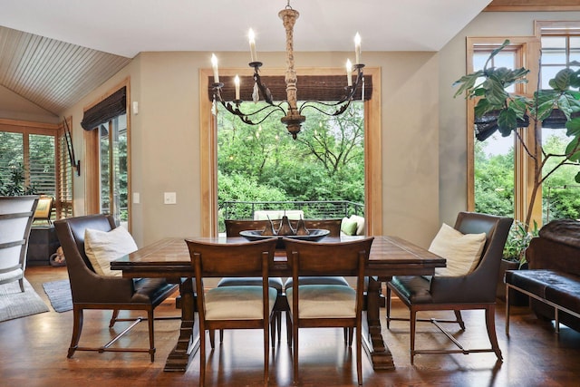 dining area with vaulted ceiling, a notable chandelier, and dark hardwood / wood-style flooring