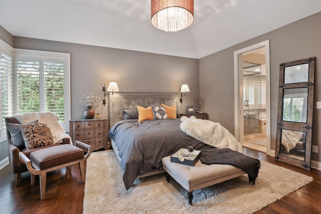 bedroom with dark hardwood / wood-style flooring and a notable chandelier